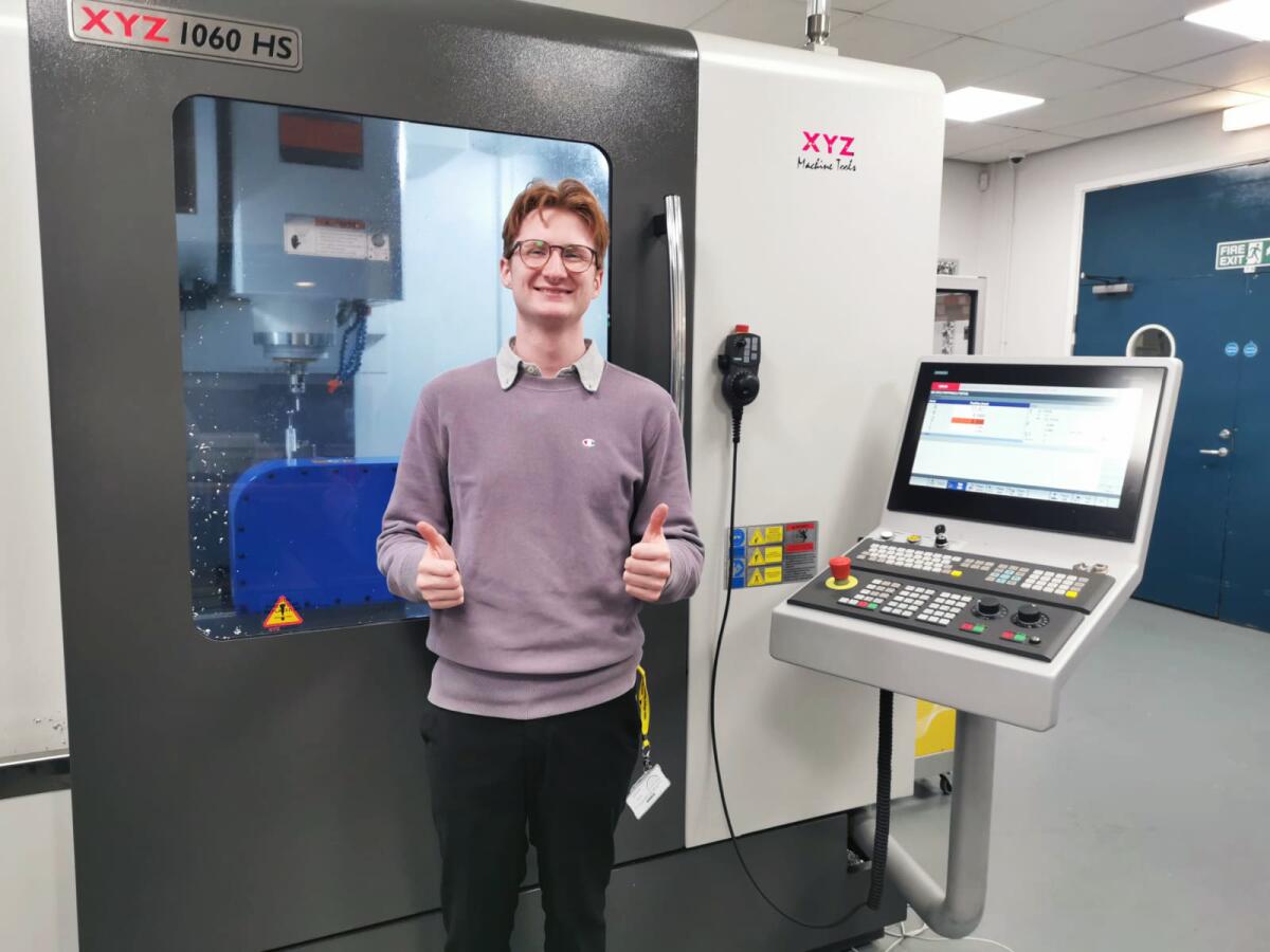 Mitchel in front of an XYZ CNC machine tool at Newcastle College