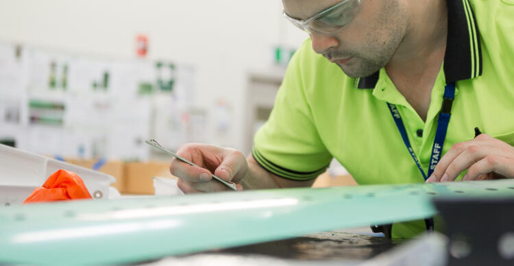 Quickstep Technologies worker with a composite part